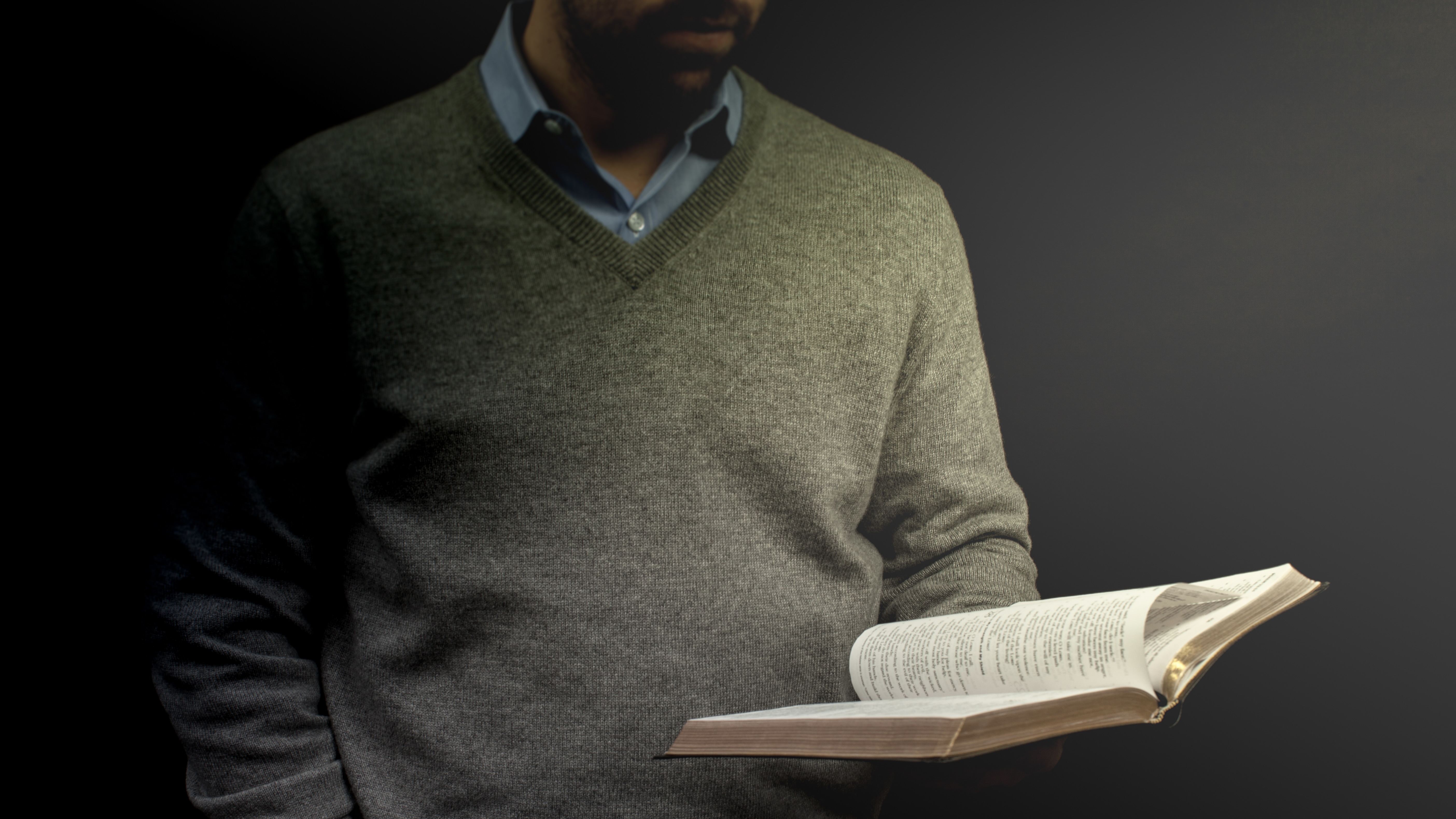 a_preacher_holding_a_bible_during_his_sermon-5616x3744