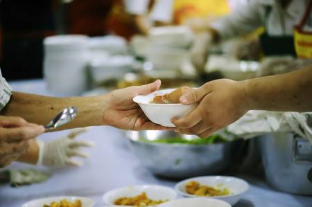 110778167-volunteers-share-food-to-the-poor-to-relieve-hunger-charity-concept image
