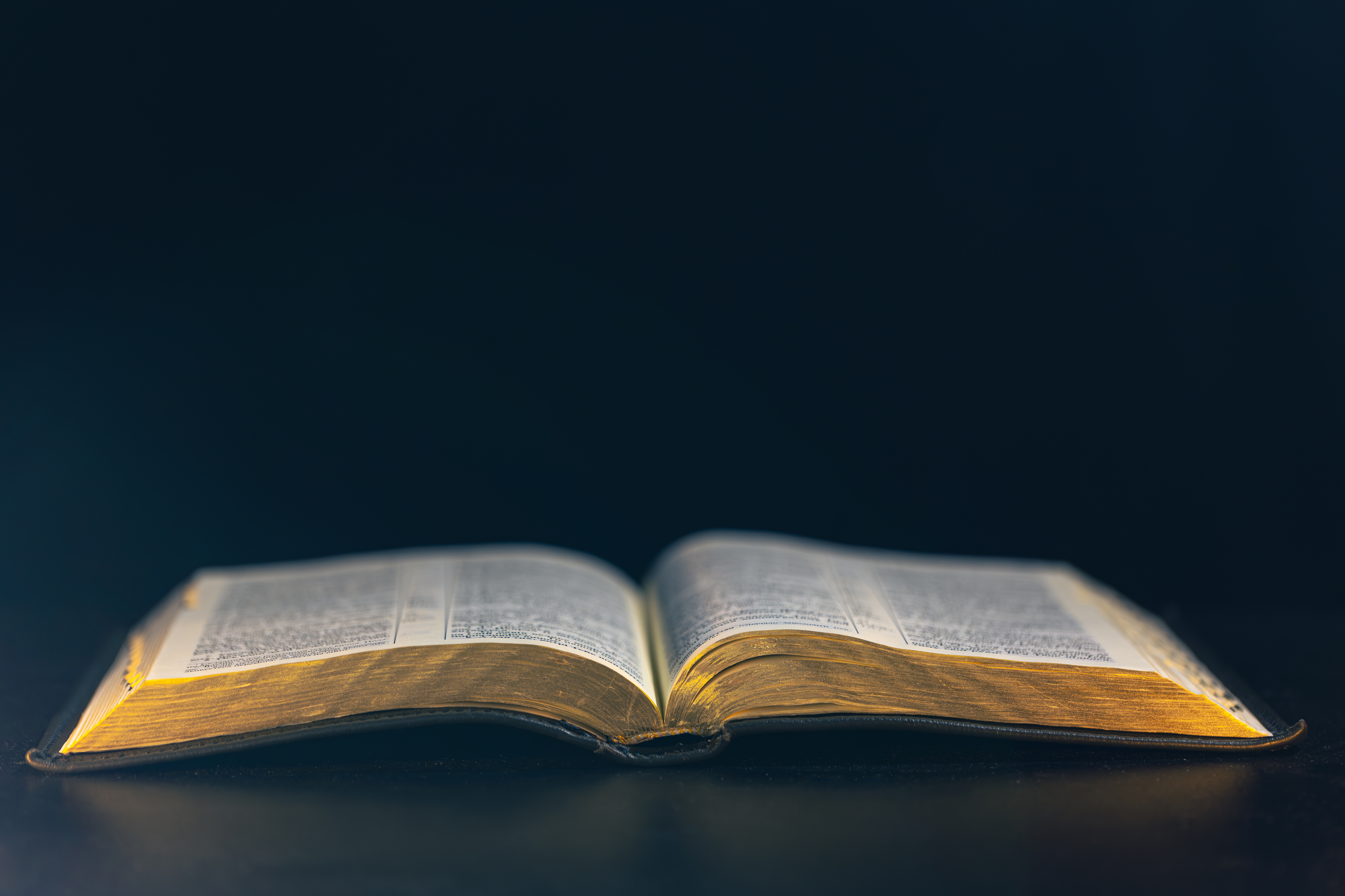 open-bible-black-background-religion-concept