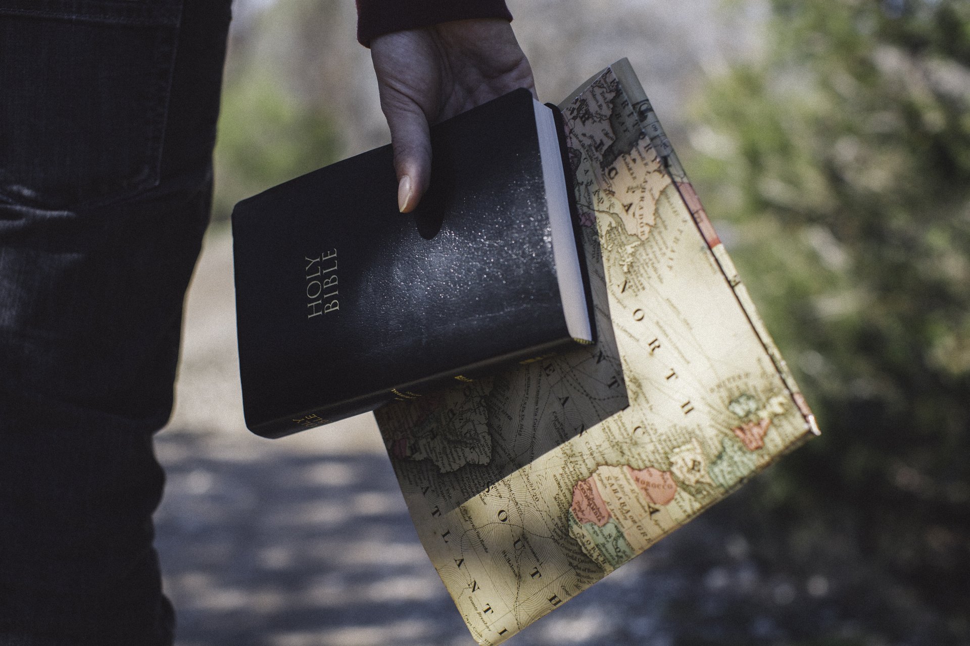 man_holding_a_bible_and_world_map-1920x1280