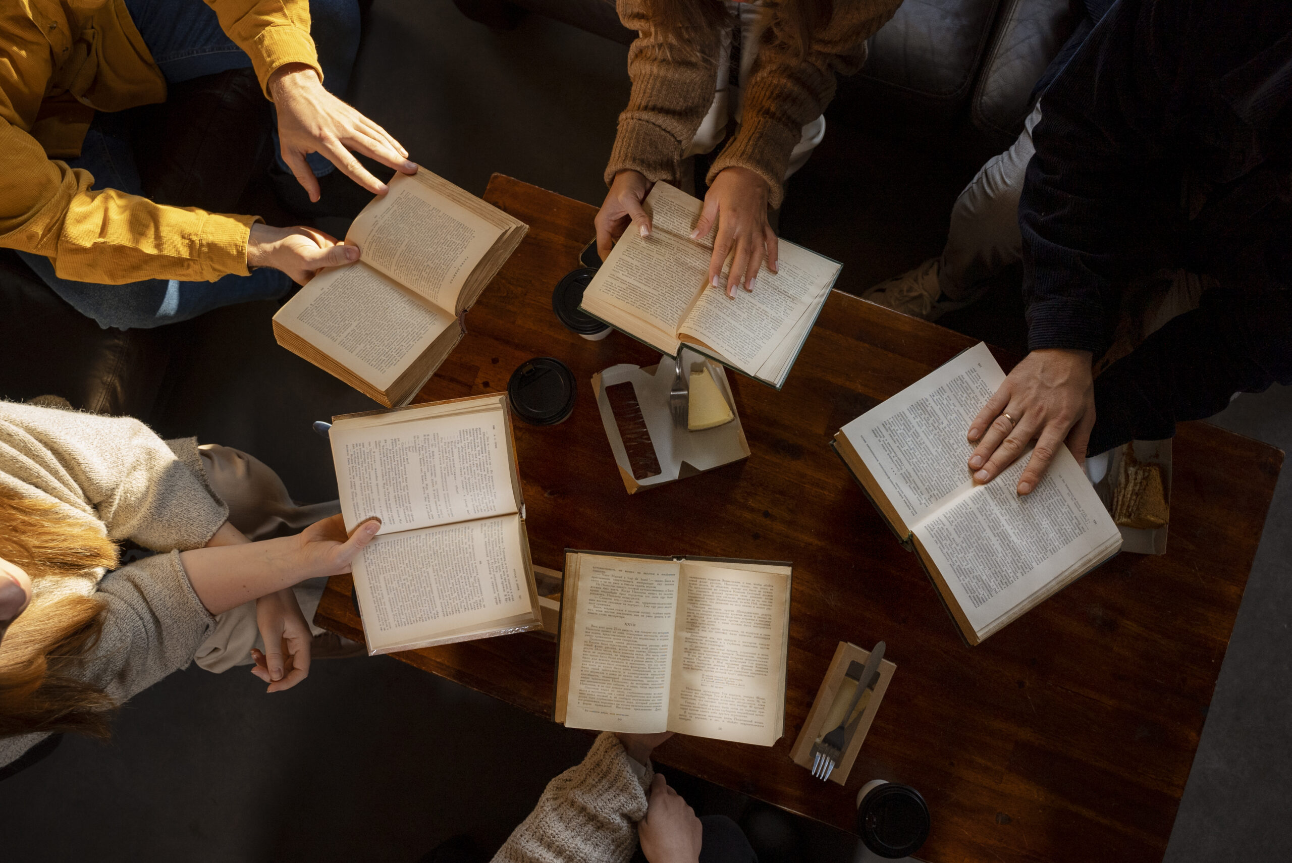 top-view-people-reading-together-1-scaled image
