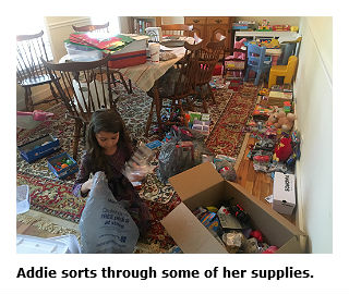 Addyson Nifong sorting through supplies for her shoebox gifts