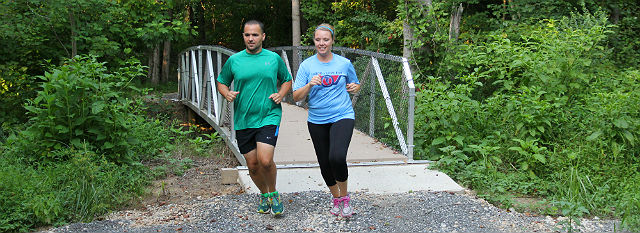 Jim and Bekah Billock run across one of the bridges on the new trail
