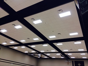 Photo of ceiling tiles and lights in new Worship Center/Gym designed to improve sound