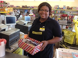 Employee at Dollar General with Operation Snack Friday box