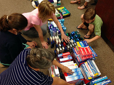 Doulos class members sort toiletries for Salvation Army kits