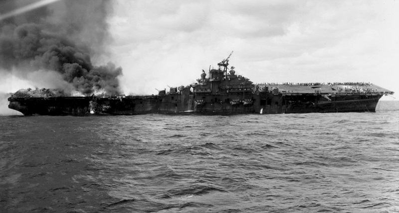 Wide photo of USS Franklin on fire after being attacked on March 19, 1945 off the coast of Japan