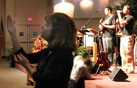 Michelle Hailey signs a song during the Contemporary Worship service