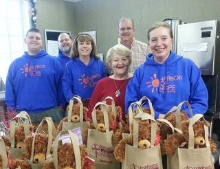 Tyler Corns, Terry Corns, Michelle Hailey, Mark Quinn, Diane Brown, and Diane Pearson deliver gift bags to Hospice