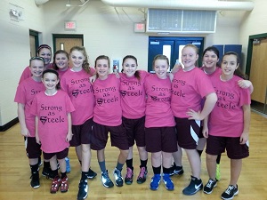Members of the Lady Titans wear their warm-up T-shirts supporting Angie Steele