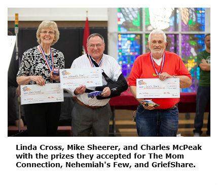 Photo of Linda Cross, Mike Sheerer, and Charles McPeak with awards for their outreach ministries