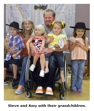 Photo of Steve and Amy Woodall with their grandchildren