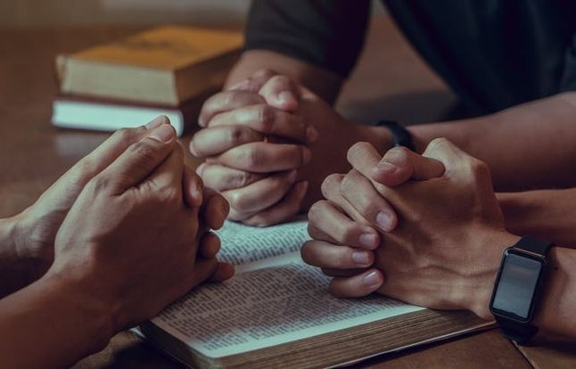 Men in Prayer cropped image